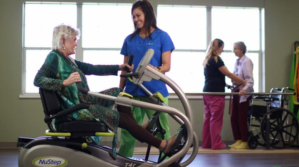 ER Senior Management | Resident exercising with the help of associate